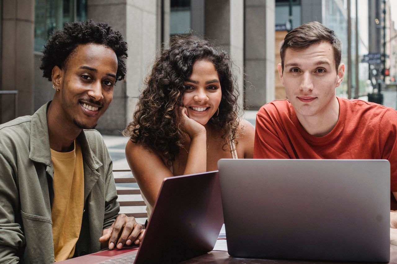 Drei Personen beim gemeinsamen Lernen am Laptop